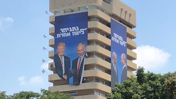 В Тель-Авиве на офисе правящей партии появились плакаты с Нетаньяху, жмущим руку Путину и Трампу